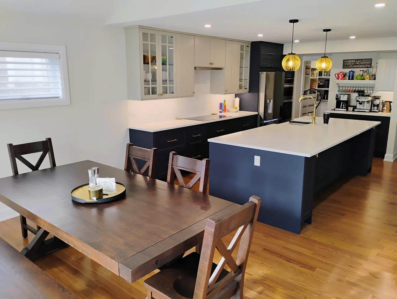 A renovated kitchen and dining space with blue cabinetry